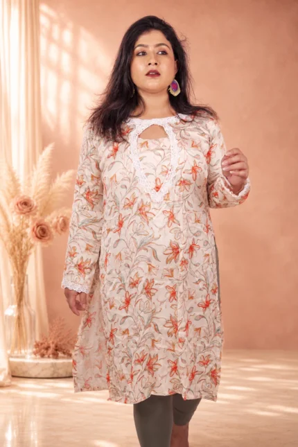 Full-length front view of a model wearing a premium cream floral silk kurti, highlighting its graceful straight fit and peach floral print.