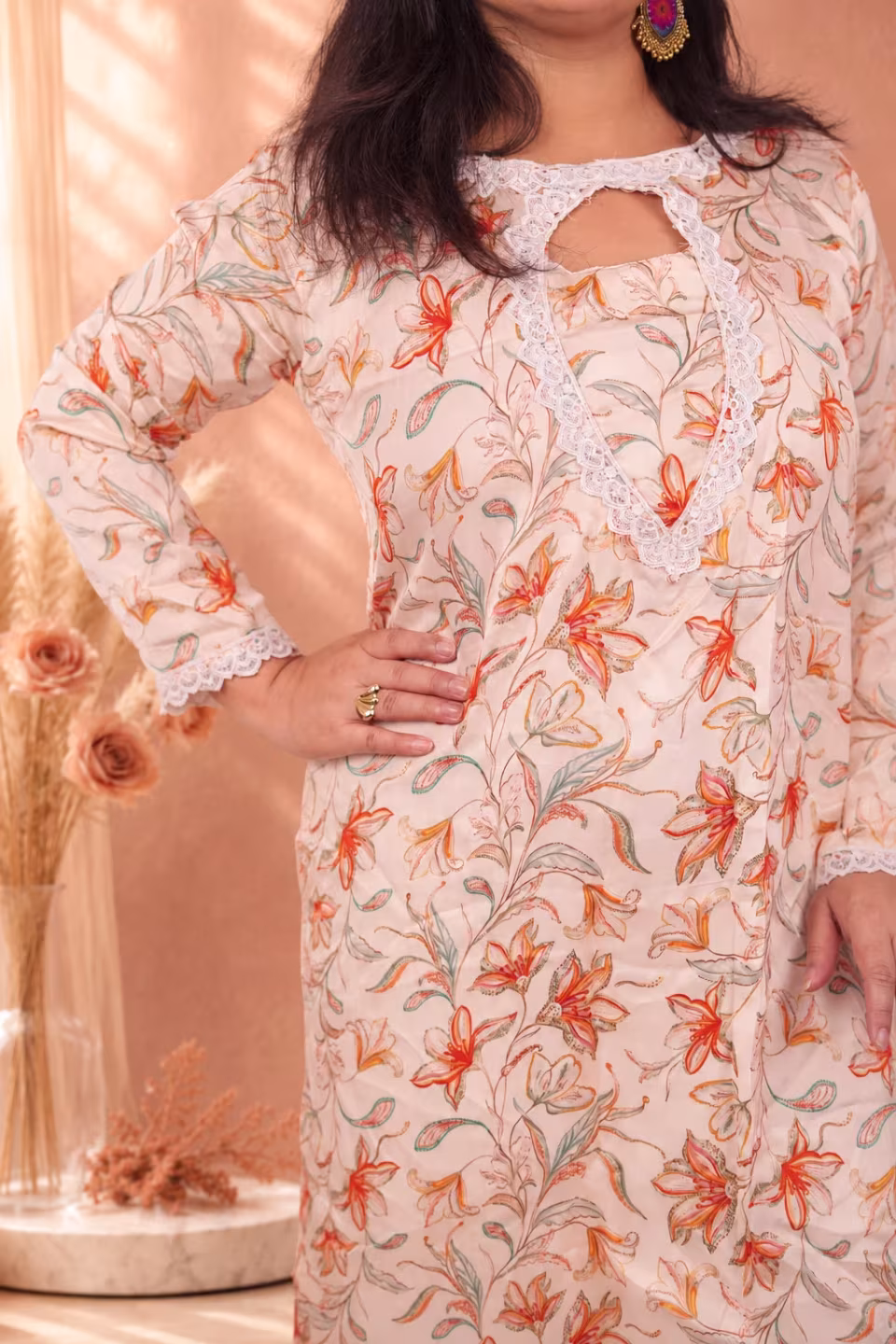 A confident side profile pose of a model wearing the cream floral silk kurti, showcasing the fit and vibrant floral print of the silk fabric.