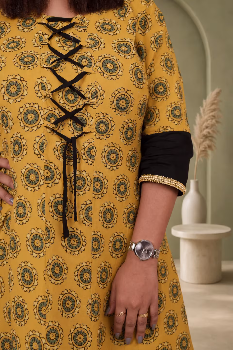 Close-up of Bagru block print pattern and black lace-up front detail on mustard yellow cotton kurti