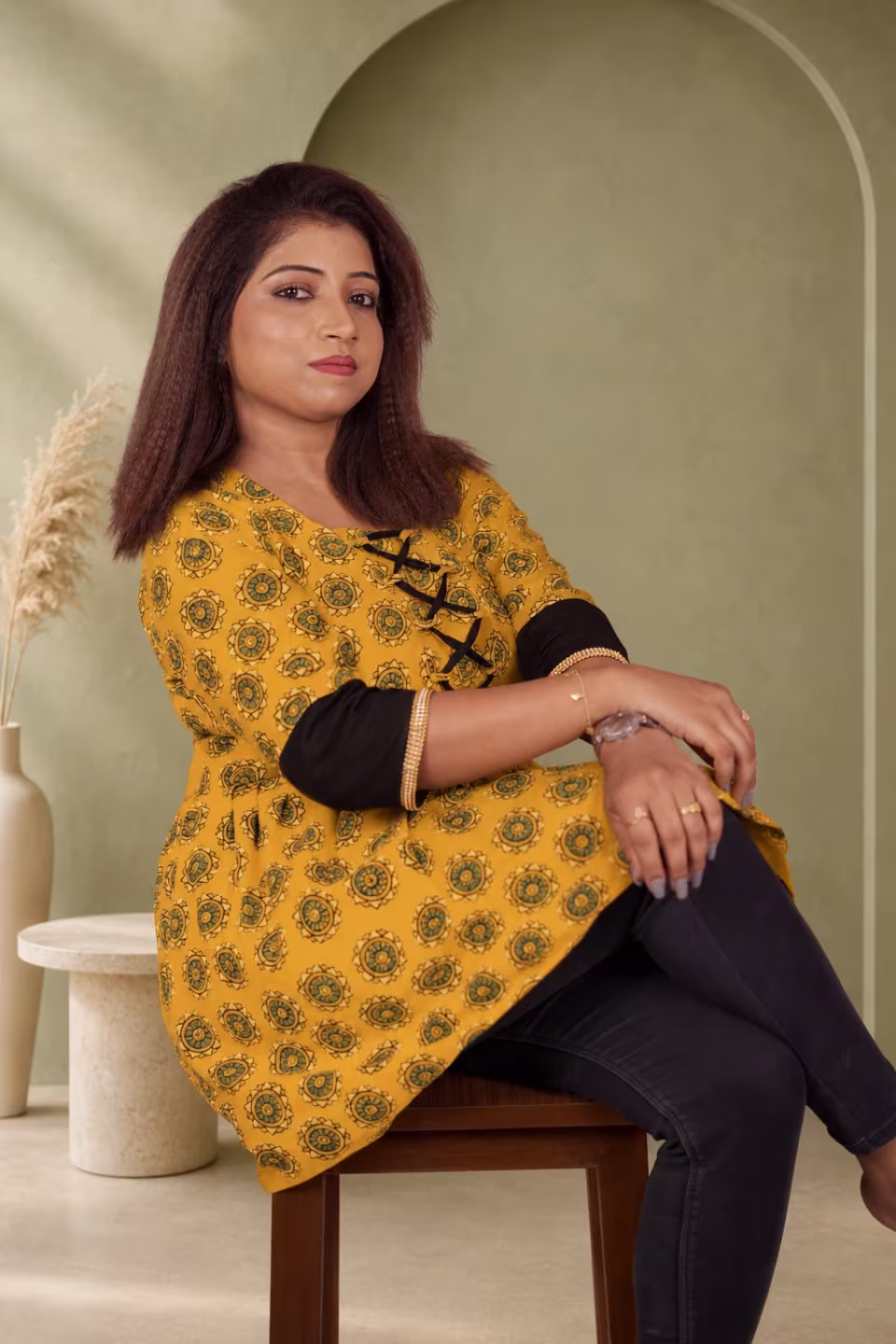Mustard Bagru block print kurti side seated view showing A-line flare and black contrast 3/4 sleeve