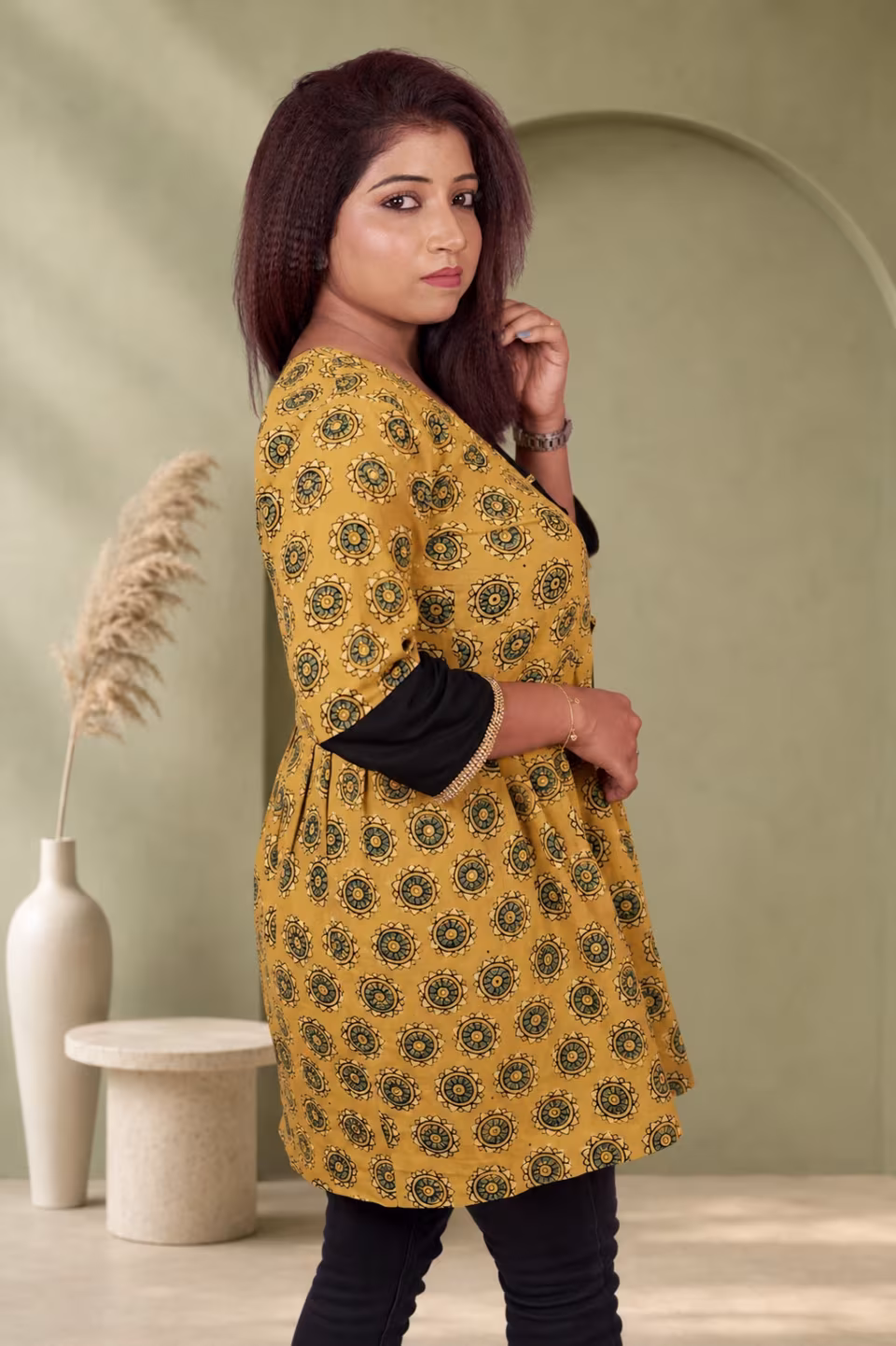 Full front view of mustard yellow Bagru block print A-line kurti with lace-up front and black contrast sleeves